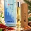 Aksa BAKARAT 9 ml Roll-On Esans kutusu, şişesi ve kahverengi taşıma kılıfı